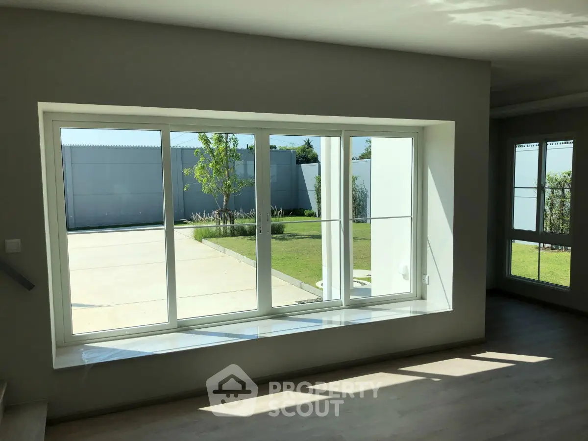 Spacious modern living room with large windows and garden view