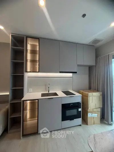 Modern kitchen with sleek cabinetry and built-in appliances in a stylish apartment.