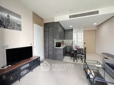 Modern living room with open kitchen layout and stylish decor
