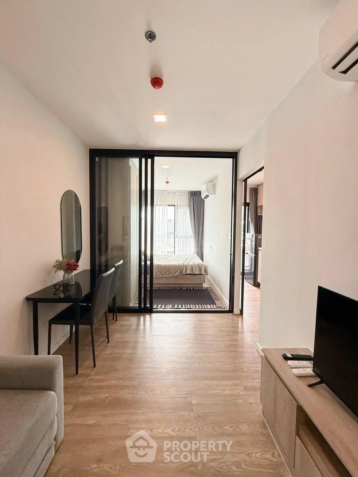 Modern apartment interior with open layout, featuring a cozy living area and stylish bedroom.