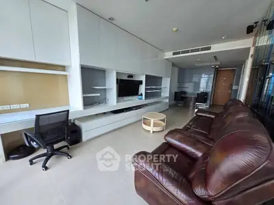 Spacious modern living room with leather sofa and built-in entertainment center