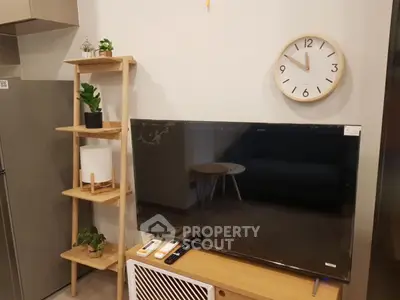 Modern living room with stylish TV setup and wooden shelving