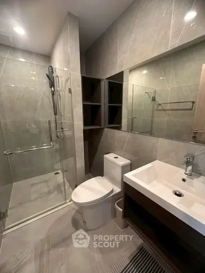 Modern bathroom with glass shower and sleek fixtures