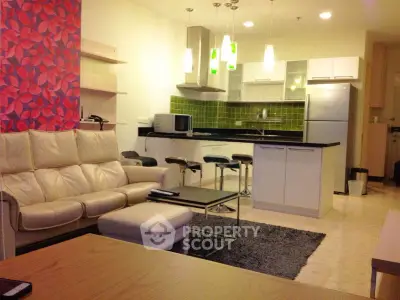 Modern open-plan living room with stylish kitchen and cozy seating area