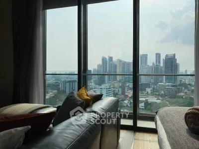 Luxurious living room with stunning city skyline view from large windows.