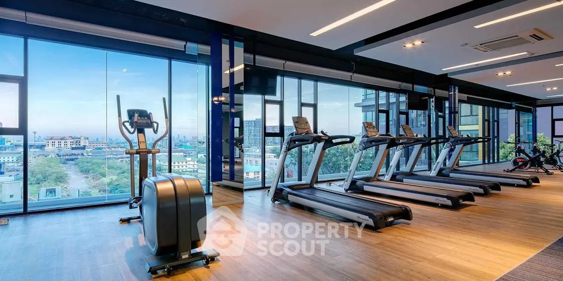 Modern gym with panoramic city views and state-of-the-art equipment.