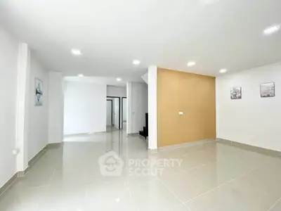Spacious modern living room with glossy tiled floors and minimalist decor