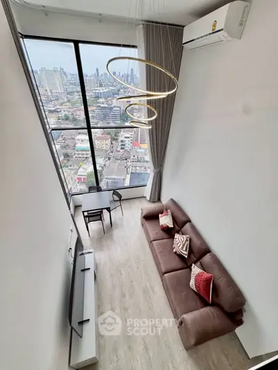 Stunning high-rise living room with panoramic city view and modern decor.