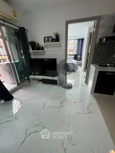 Modern apartment interior with marble flooring, open living area, and balcony access.