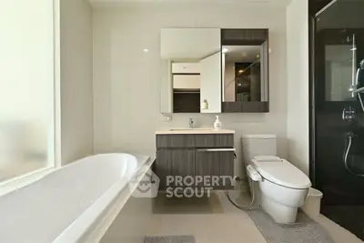 Modern bathroom with sleek fixtures and a spacious bathtub in a contemporary home.
