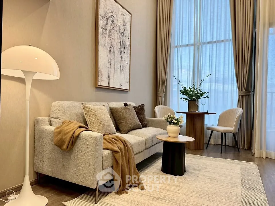 Elegant living room with high ceilings, modern decor, and large windows for natural light.