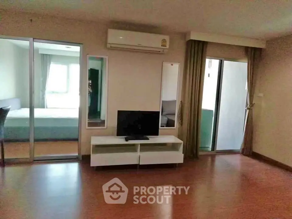 Spacious living room with modern decor and balcony access in a stylish apartment.