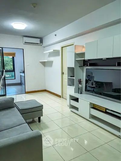 Modern living room with sleek furniture and open kitchen view