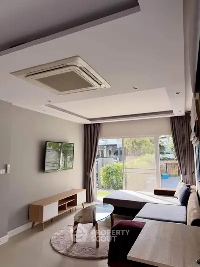 Modern living room with large window and stylish furniture