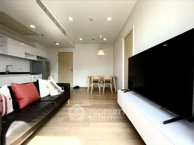 Modern living room with sleek furniture and open kitchen layout, perfect for contemporary living.