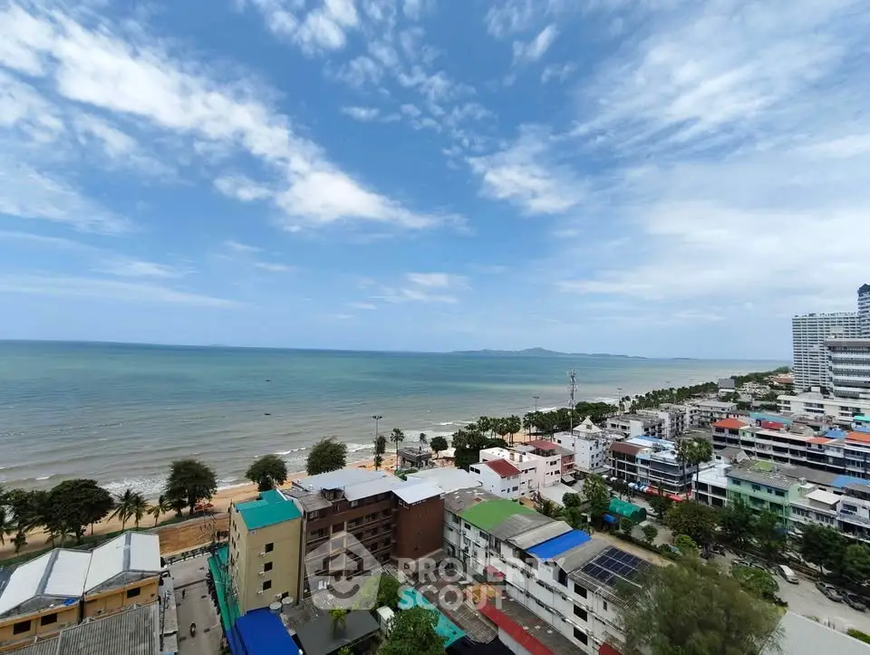 Stunning beachfront view from high-rise building overlooking ocean and coastline.