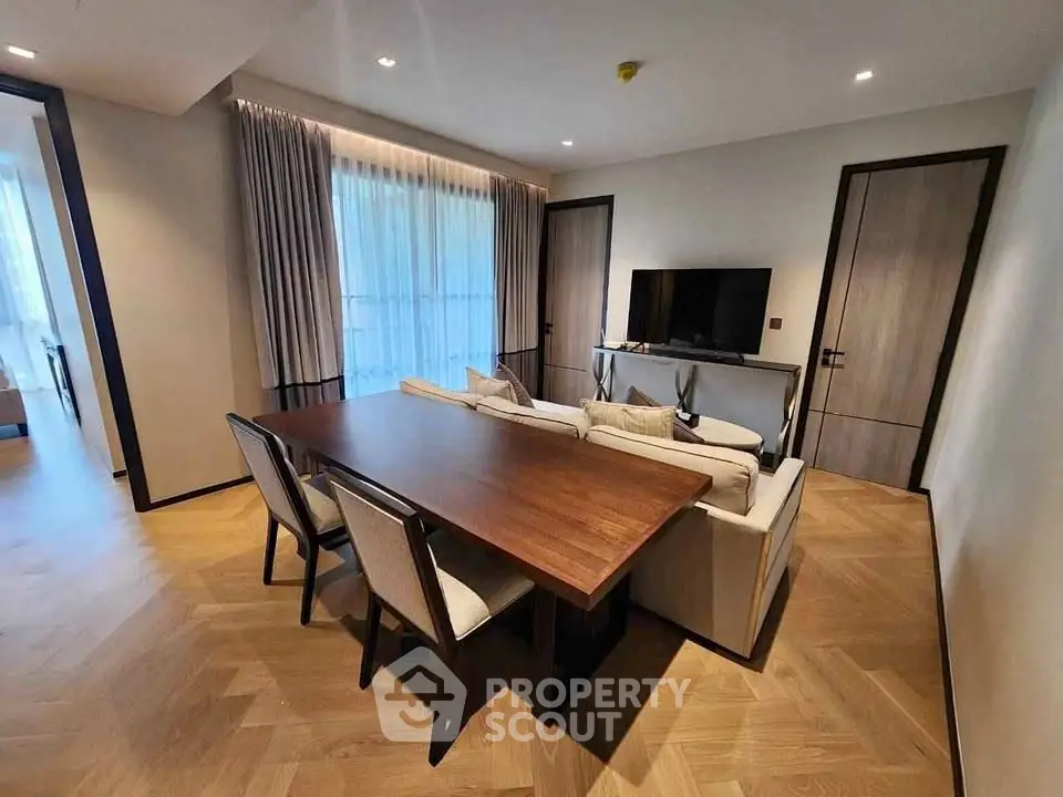 Modern living room with elegant dining table and cozy seating area.