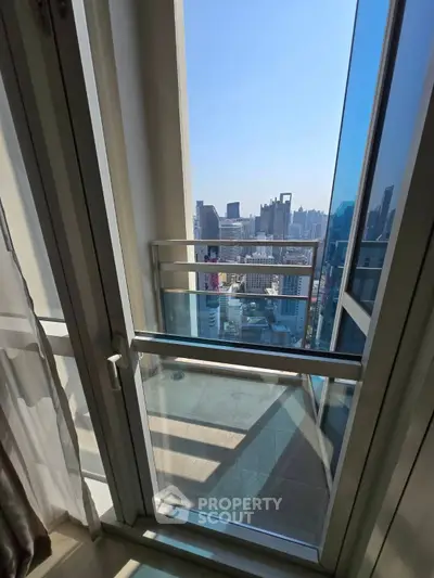Stunning city view from modern apartment balcony with glass railing
