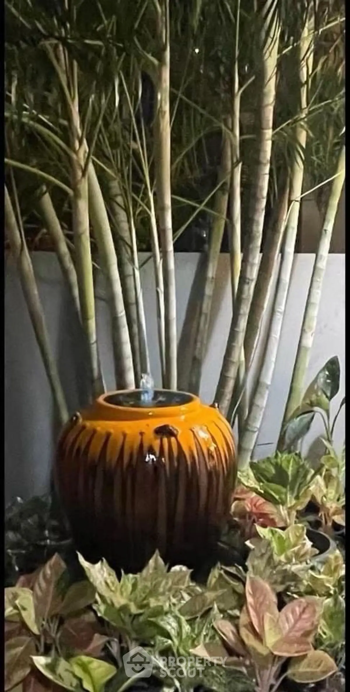 Serene garden with bamboo and decorative water feature for tranquil outdoor living.