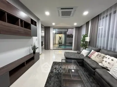 Luxurious living room with pool view, modern furniture, and elegant decor