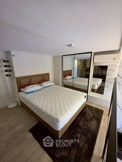 Modern bedroom with mirrored wardrobe and cozy decor
