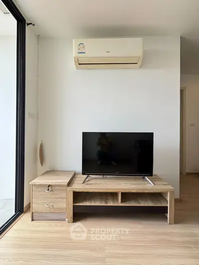 Modern living room with air conditioning and sleek TV setup