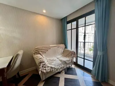 Cozy living room with stylish sofa and large window overlooking balcony