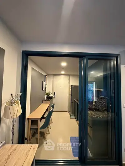 Modern kitchen with sleek design and open layout, featuring dining area and stylish lighting.