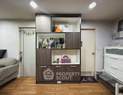 Modern living room with stylish wooden shelving unit and cozy decor