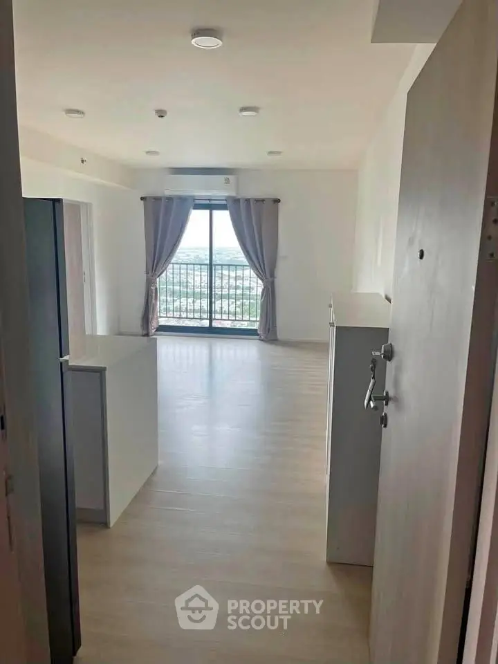 Spacious modern apartment with large windows and balcony offering stunning views.