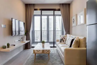 Modern living room with balcony view, stylish decor, and natural light.