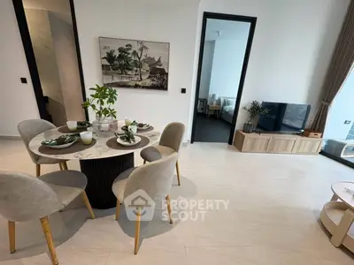 Modern open-plan living and dining area with stylish decor and natural light.