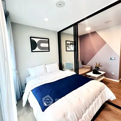 Modern bedroom with stylish decor and cozy seating area
