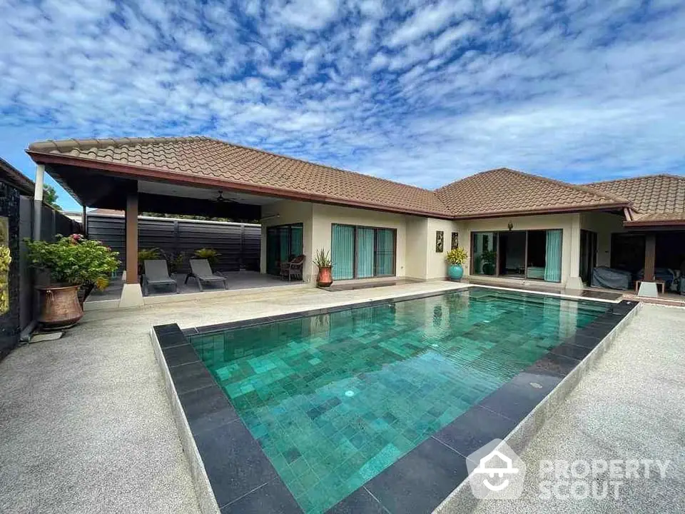 Luxurious villa with private pool and spacious patio under a vibrant sky.