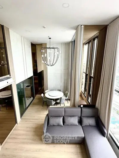Modern living room with high ceiling and large windows in a stylish apartment
