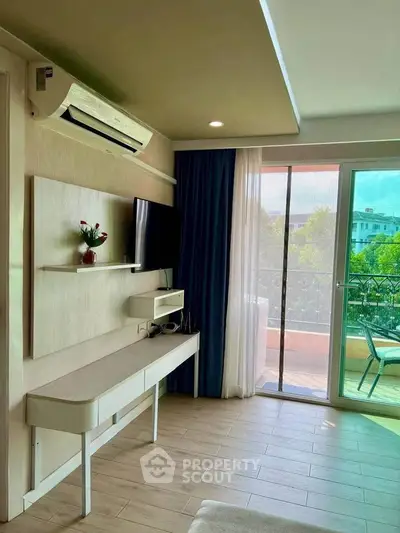 Modern living room with balcony access and stylish decor in a bright apartment.
