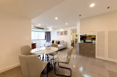 Spacious open-plan living and dining area with modern furnishings and natural light.