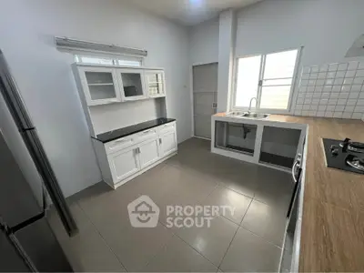 Modern kitchen with sleek countertops and gas stove in a bright, spacious layout.