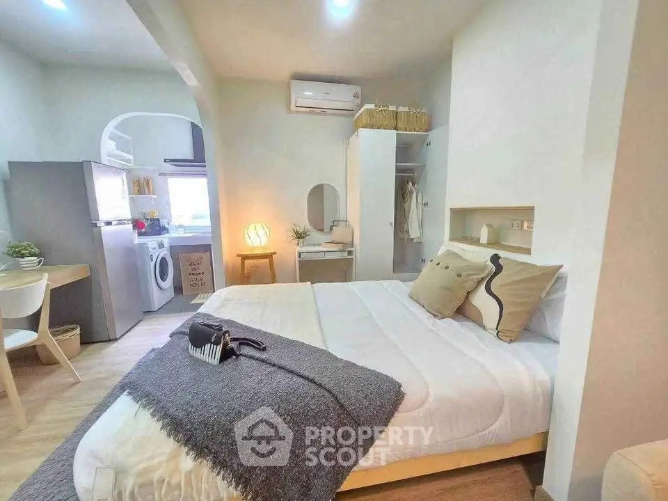 Cozy studio apartment with modern kitchen and stylish decor, perfect for urban living.