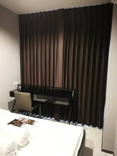 Modern bedroom with sleek desk and elegant curtains