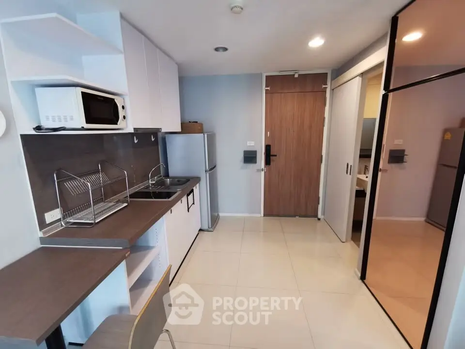 Modern kitchen with sleek appliances and open layout in a stylish apartment.
