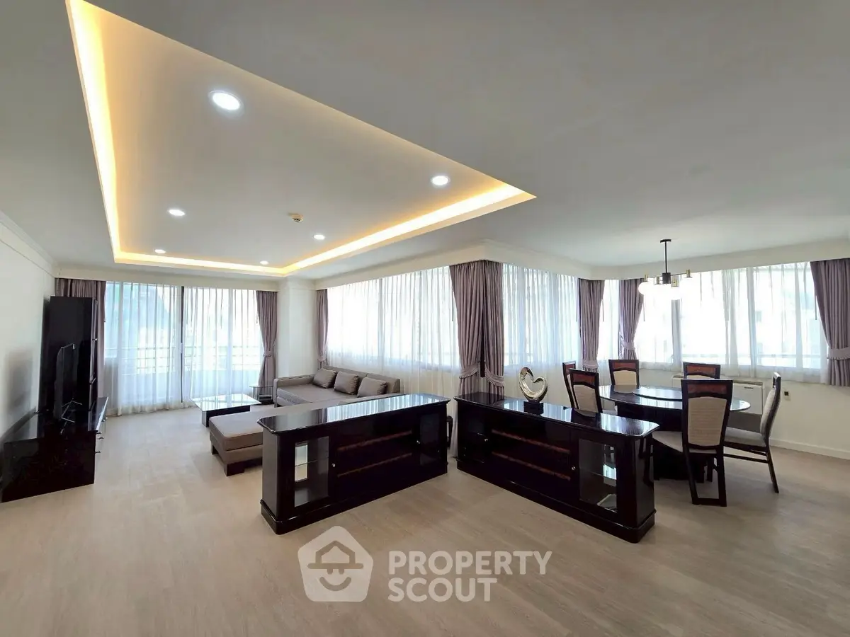 Spacious modern living room with elegant dining area and large windows