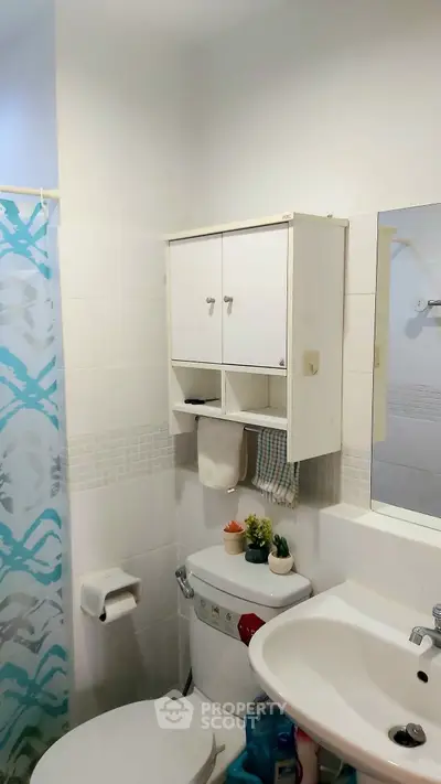 Cozy bathroom with modern fixtures and decorative accents.