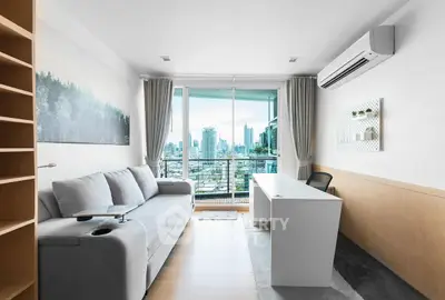 Modern living room with city view, featuring sleek furniture and air conditioning.