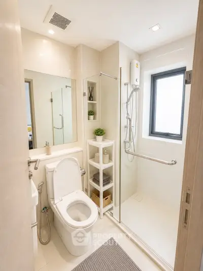 Modern bathroom with sleek shower and elegant fixtures in a bright, compact space.