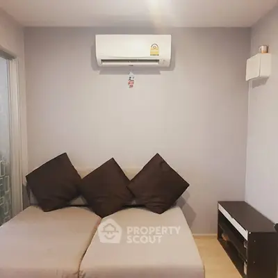 Cozy living room with modern air conditioning and stylish sofa, perfect for relaxation.