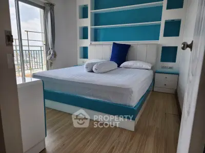 Modern bedroom with blue accents and balcony view in high-rise apartment