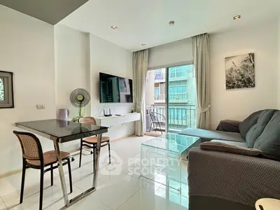 Modern living room with balcony view, sleek furniture, and natural light in urban apartment.
