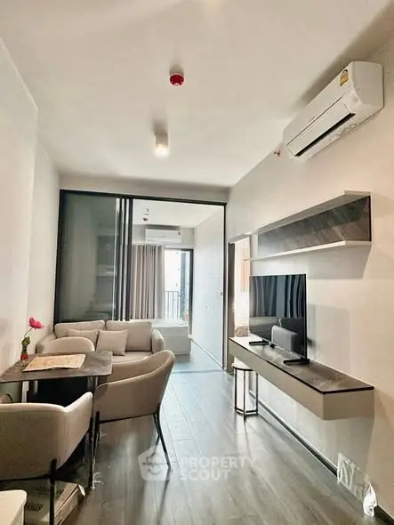 Modern living room with sleek furniture and air conditioning in a stylish apartment.