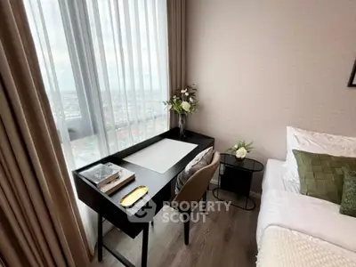 Stylish bedroom with a modern study desk and city view.